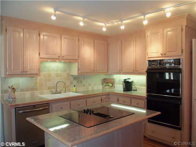 3020 Vistapoint Road Midlothian, VA 23113 - Photo 8 of 24 a kitchen with a sink a stove and cabinets