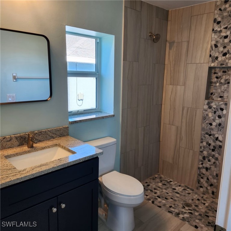 5651 Genesee Parkway, Unit 5651 Bokeelia, FL 33922 - Photo 14 of 27 a bathroom with a sink a toilet and shower