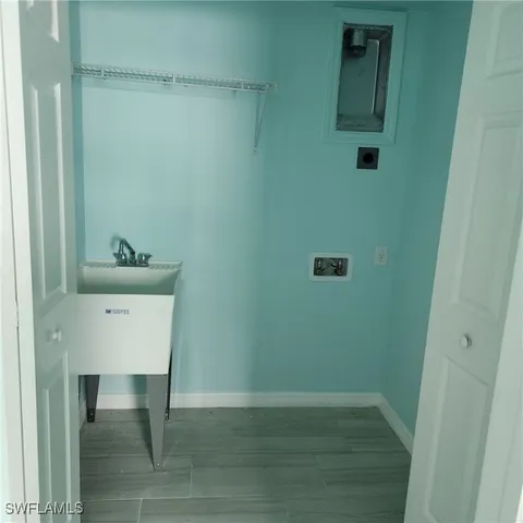 an empty room with wooden floor and a window