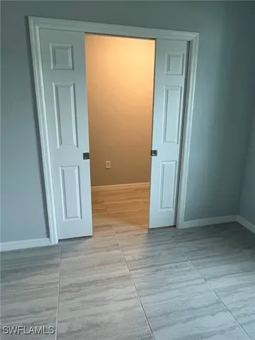 a view of a room with wooden floor and a floor to ceiling window