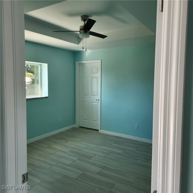 5651 Genesee Parkway, Unit 5651 Bokeelia, FL 33922 - Photo 21 of 27 a view of an empty room with wooden floor and a window