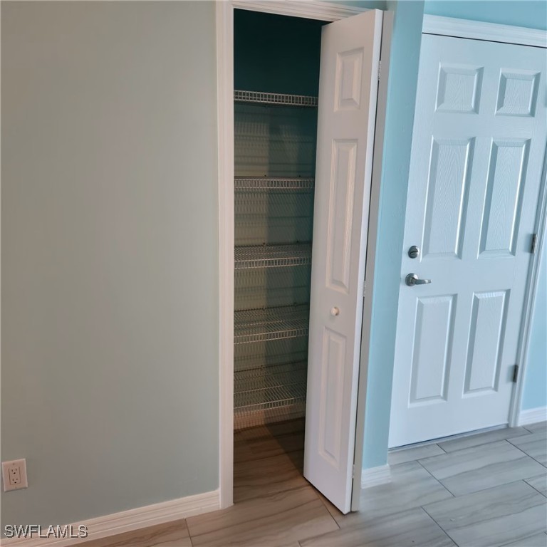 5651 Genesee Parkway, Unit 5651 Bokeelia, FL 33922 - Photo 23 of 27 an empty room with wooden floor