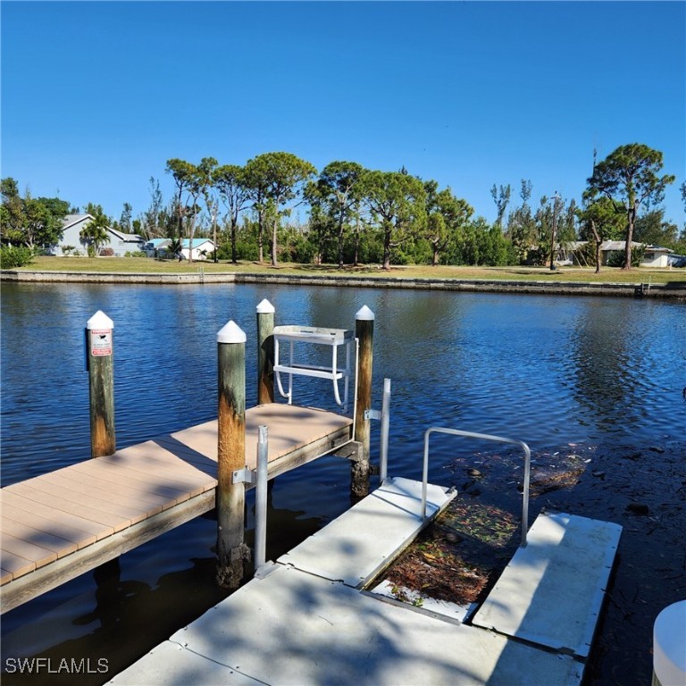 5651 Genesee Parkway, Unit 5651 Bokeelia, FL 33922 - Photo 5 of 27 a view of a balcony with chairs and wooden floor