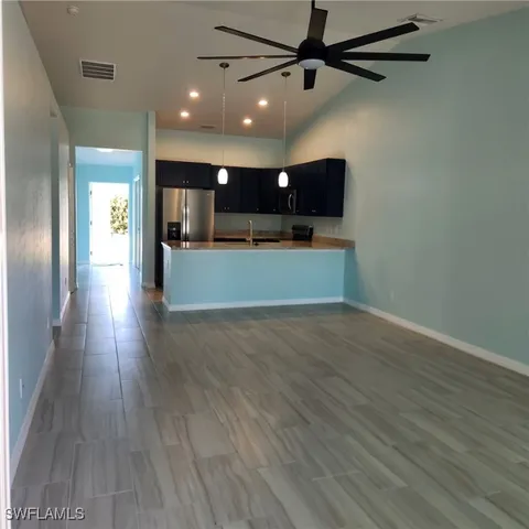 a kitchen with stainless steel appliances granite countertop a refrigerator a stove a sink and dishwasher