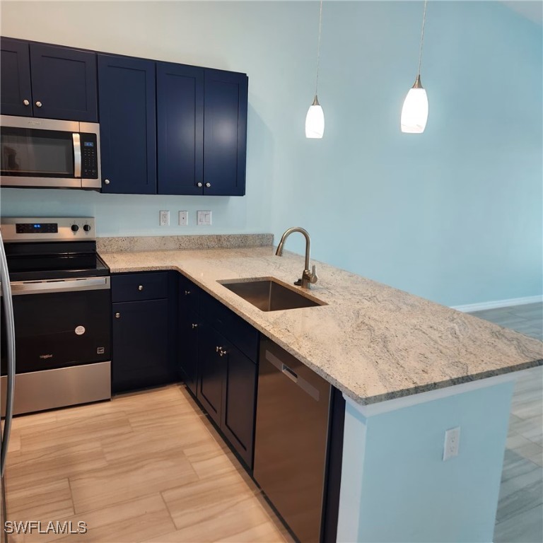 5651 Genesee Parkway, Unit 5651 Bokeelia, FL 33922 - Photo 9 of 27 a kitchen with a sink and a stove with wooden floor