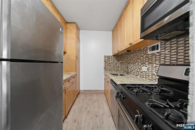 a kitchen with a refrigerator and a stove