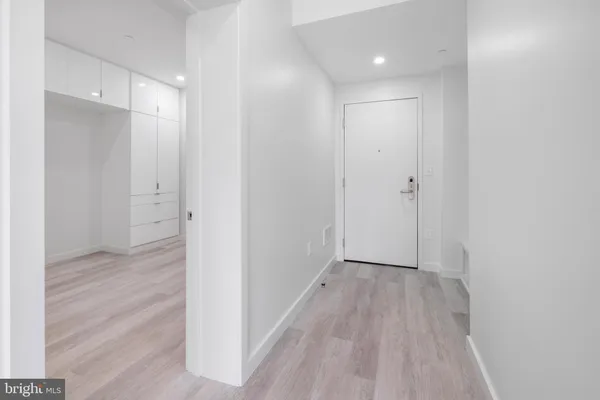 a view of hallway with wooden floor