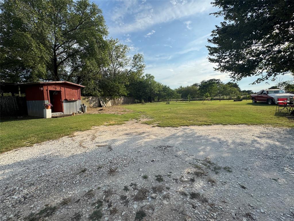 608 Cherokee Street Bellmead, TX 76705 - Photo 2 of 38 a view of a house with big yard and large trees