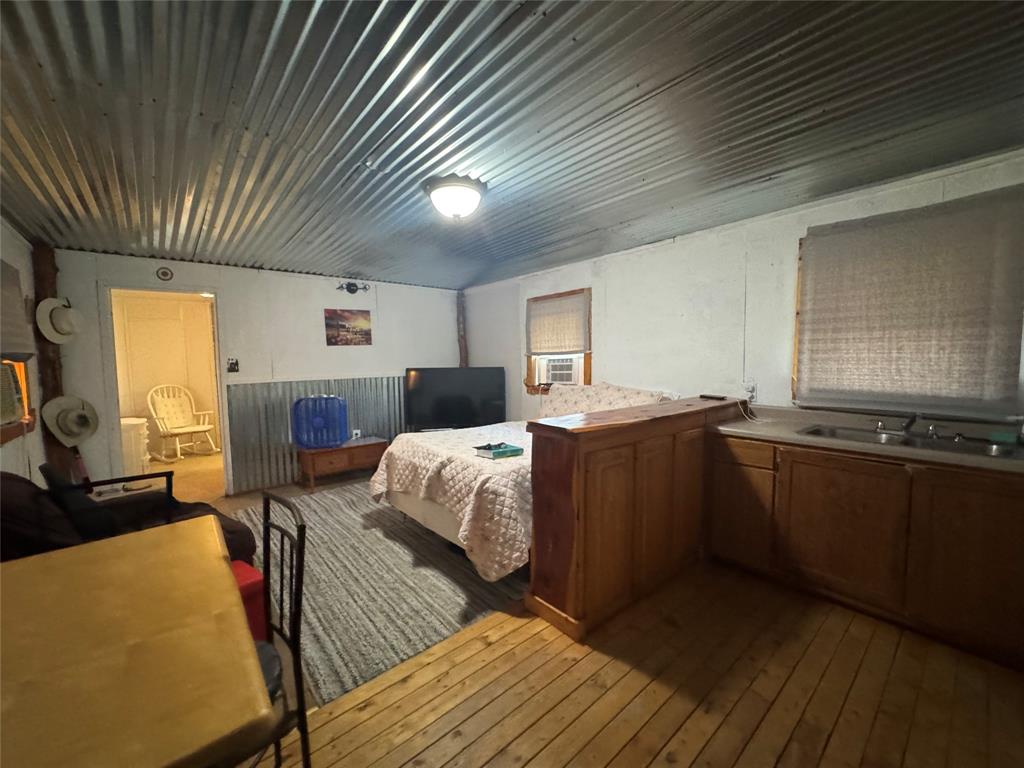 608 Cherokee Street Bellmead, TX 76705 - Photo 22 of 38 a kitchen with stainless steel appliances granite countertop a refrigerator a sink dishwasher a stove and white countertops with wooden floor