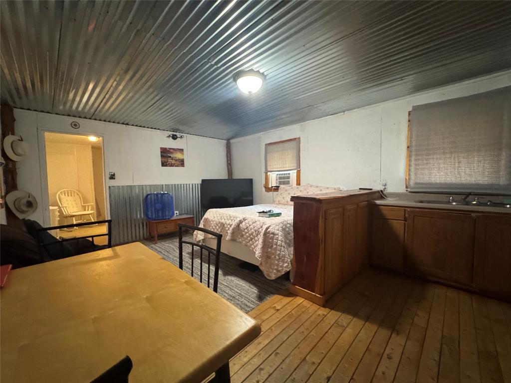 608 Cherokee Street Bellmead, TX 76705 - Photo 25 of 38 a bedroom with a bed and wooden floor