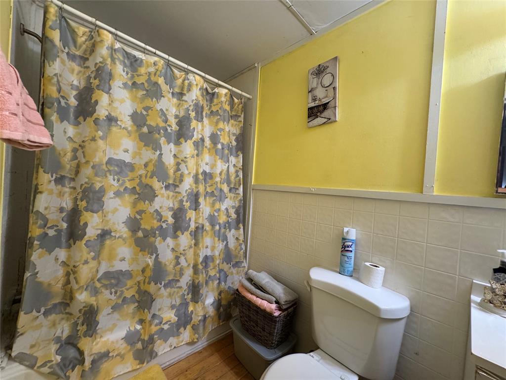 608 Cherokee Street Bellmead, TX 76705 - Photo 28 of 38 a white toilet sitting next to a shower curtain