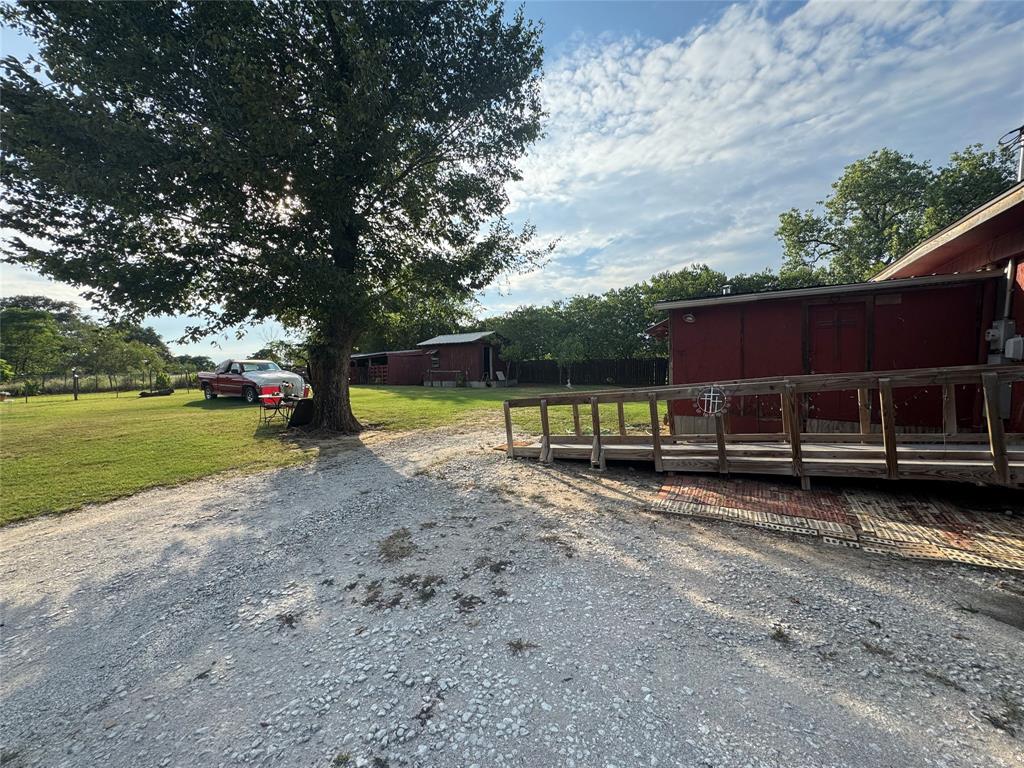 608 Cherokee Street Bellmead, TX 76705 - Photo 4 of 38 a view of a yard with wooden fence
