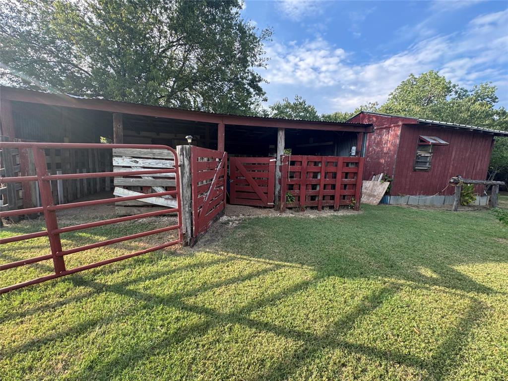 608 Cherokee Street Bellmead, TX 76705 - Photo 6 of 38 a view of a backyard with wooden fence and a large tree