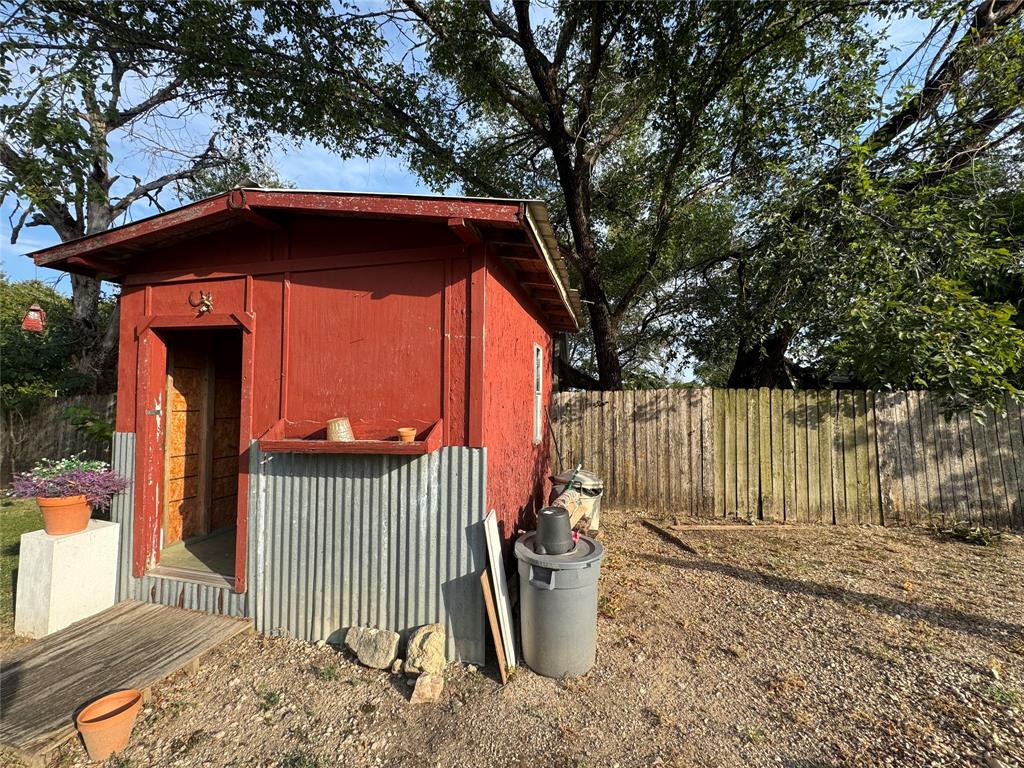 608 Cherokee Street Bellmead, TX 76705 - Photo 8 of 38 a view of a wooden house with a large window and wooden fence