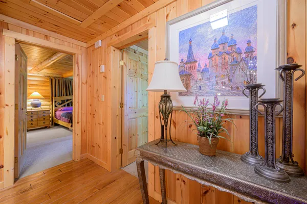 a spacious bedroom with a bed and a chandelier