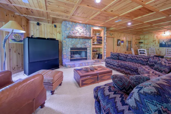 a large living room with lots of furniture and a chandelier