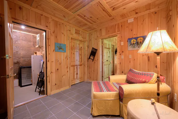 a bedroom with bed and wooden floor