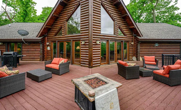 a balcony with wooden benches and barbeque oven