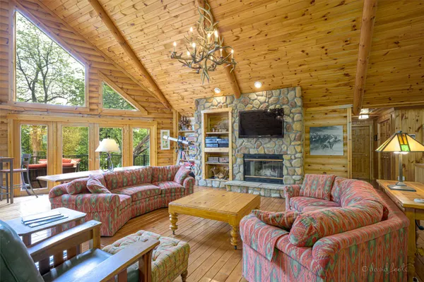 a living room with fireplace furniture and a large window