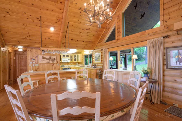 a view of a patio with dining table and chairs with wooden floor