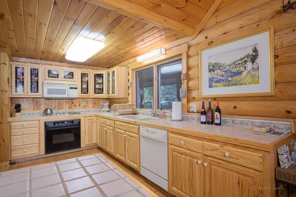 a kitchen with stainless steel appliances granite countertop a stove sink and cabinets