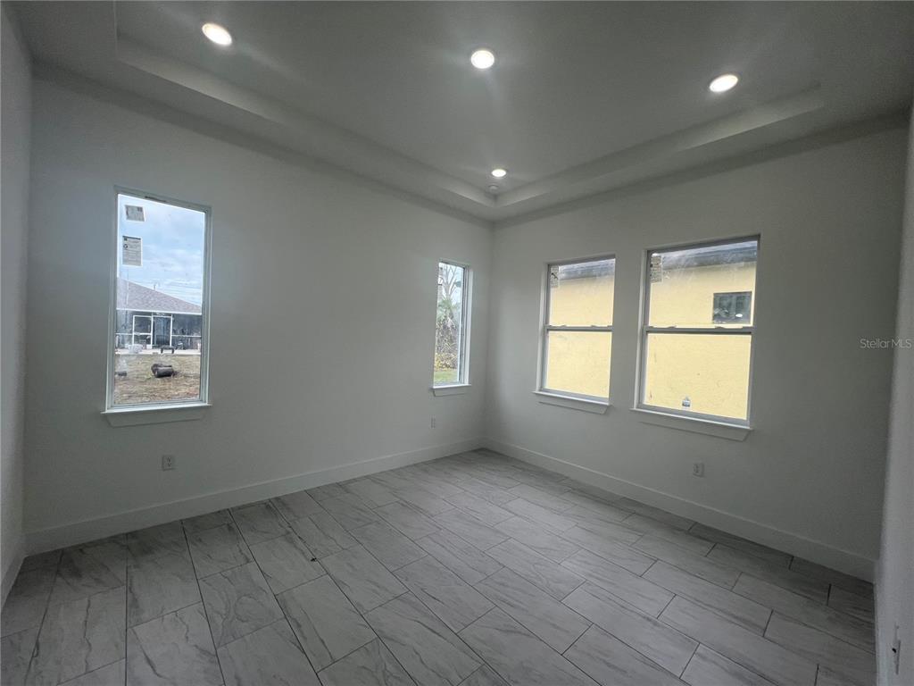 187 Sesame Road East Rotonda West, FL 33947 - Photo 12 of 28 a view of an empty room with a window and wooden floor