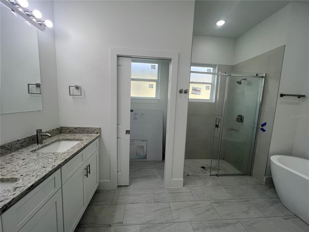 187 Sesame Road East Rotonda West, FL 33947 - Photo 14 of 28 a spacious bathroom with a granite countertop sink a toilet and shower