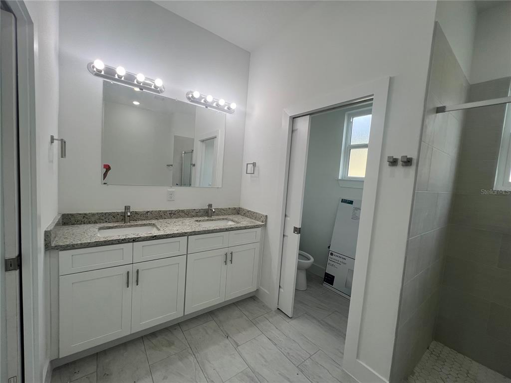 187 Sesame Road East Rotonda West, FL 33947 - Photo 17 of 28 a bathroom with a double vanity sink and a mirror