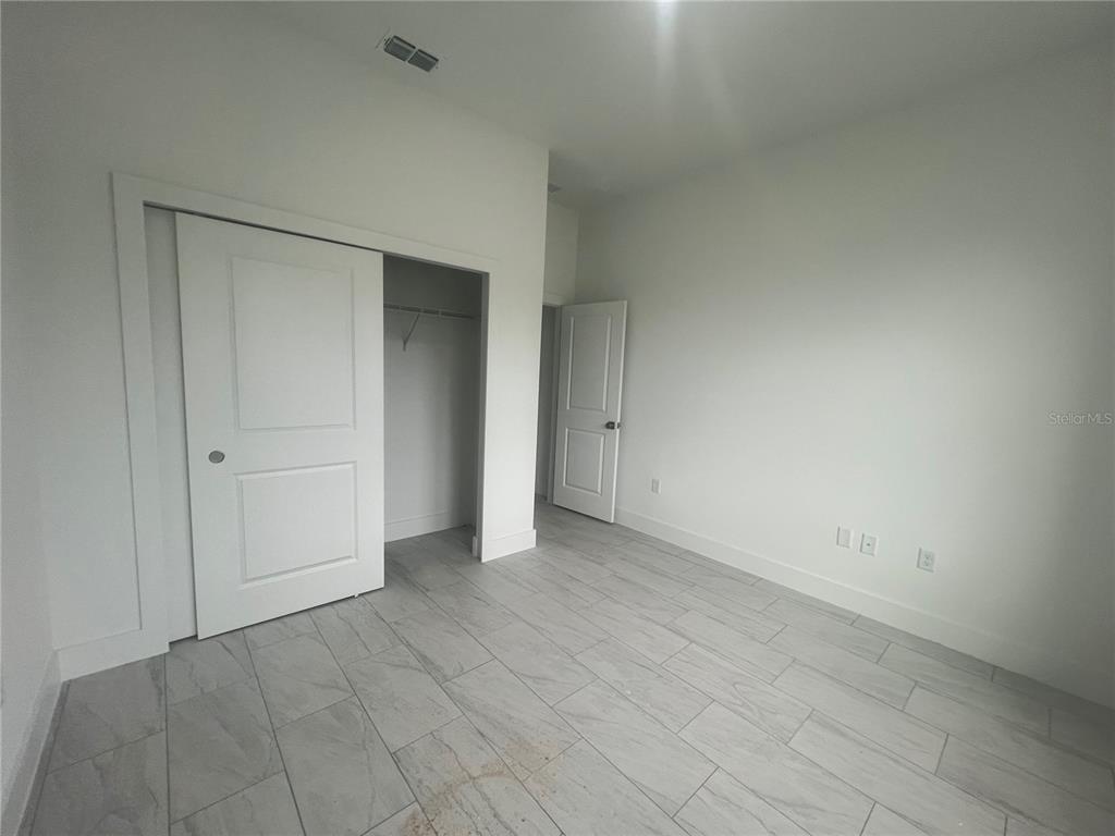 187 Sesame Road East Rotonda West, FL 33947 - Photo 25 of 28 an empty room with a natural light