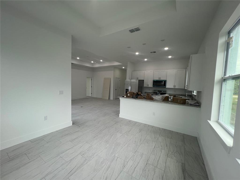 187 Sesame Road East Rotonda West, FL 33947 - Photo 7 of 28 a view of kitchen with refrigerator sink and wooden floor