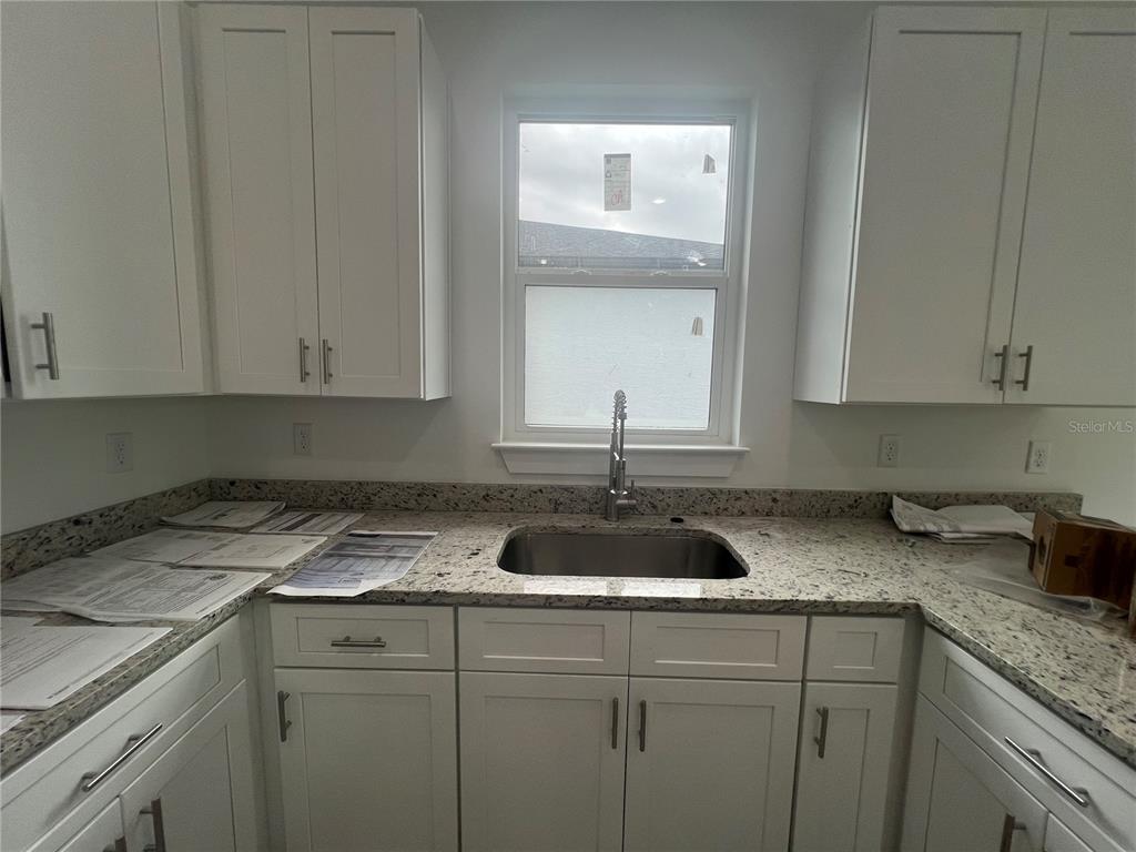 187 Sesame Road East Rotonda West, FL 33947 - Photo 8 of 28 a kitchen with a sink and cabinets