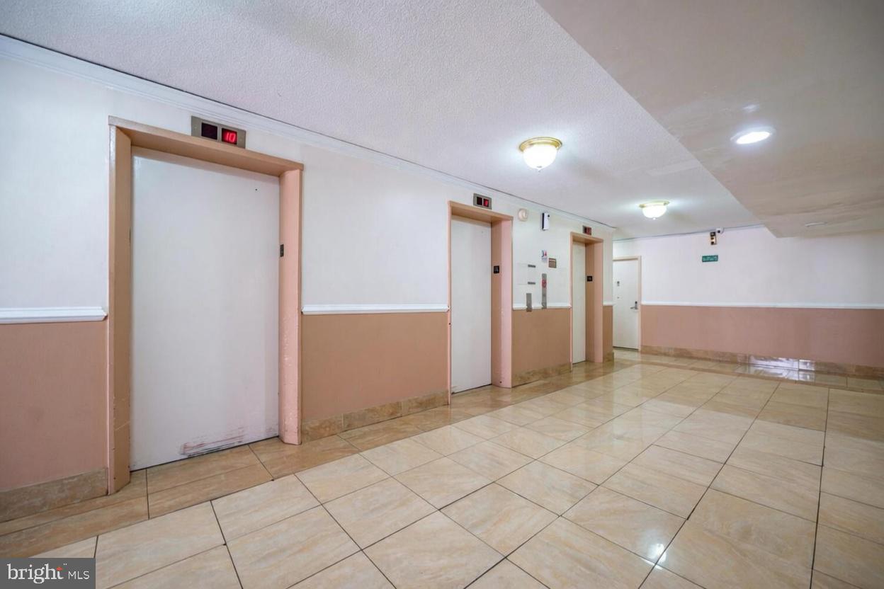 1836 Metzerott Road, Unit 1720 Hyattsville, MD 20783 - Photo 28 of 35 Elevator access in a modern corridor.