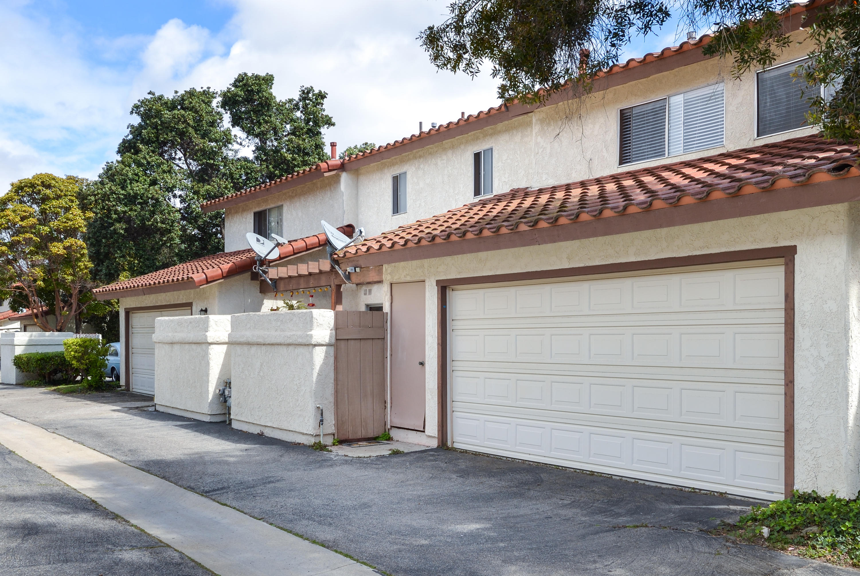 433 Percy Street Oxnard, CA 93033 - Photo 18 of 26 a view of a white house with a large space and a garage