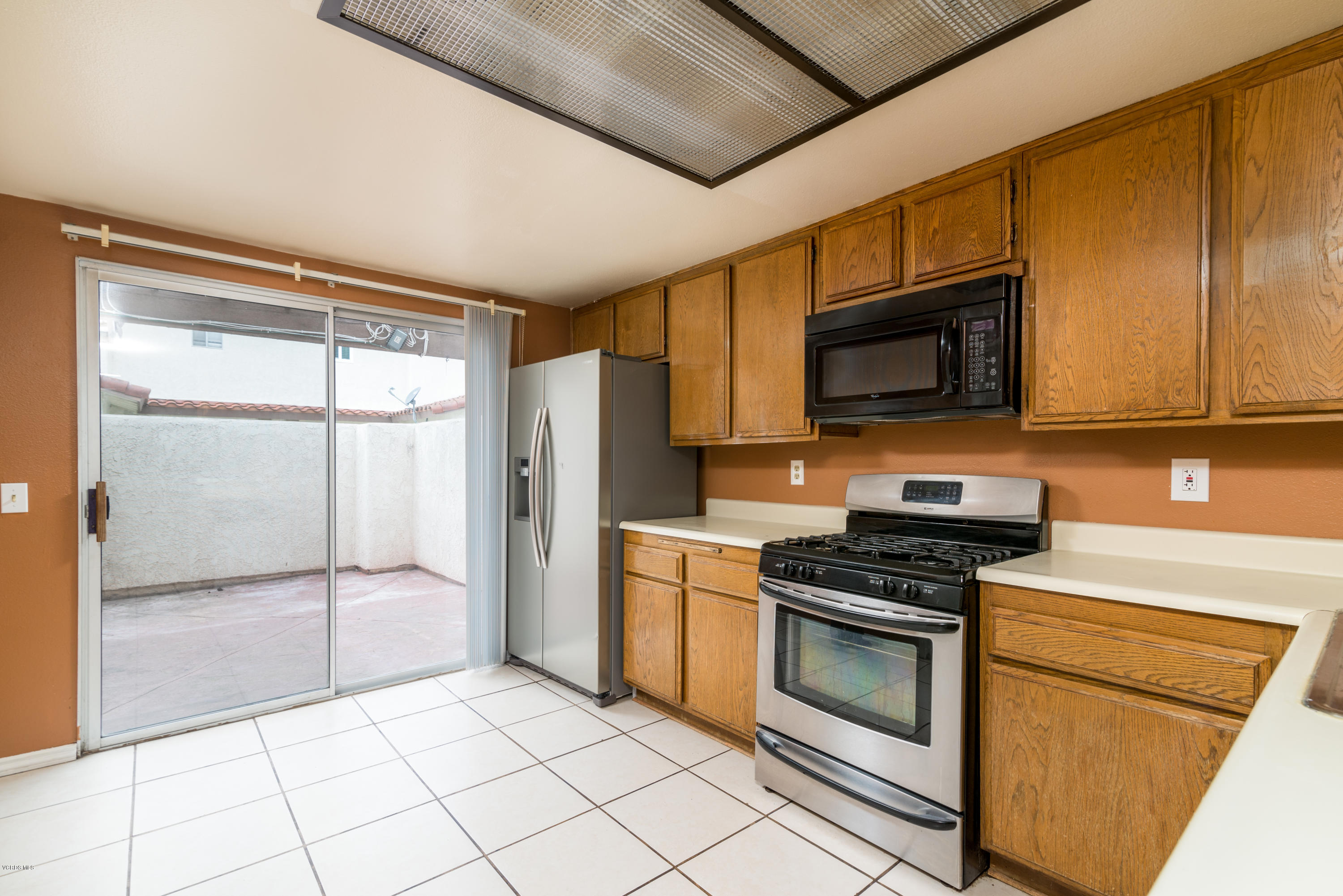 433 Percy Street Oxnard, CA 93033 - Photo 7 of 26 a kitchen with stainless steel appliances granite countertop a stove a microwave and a refrigerator
