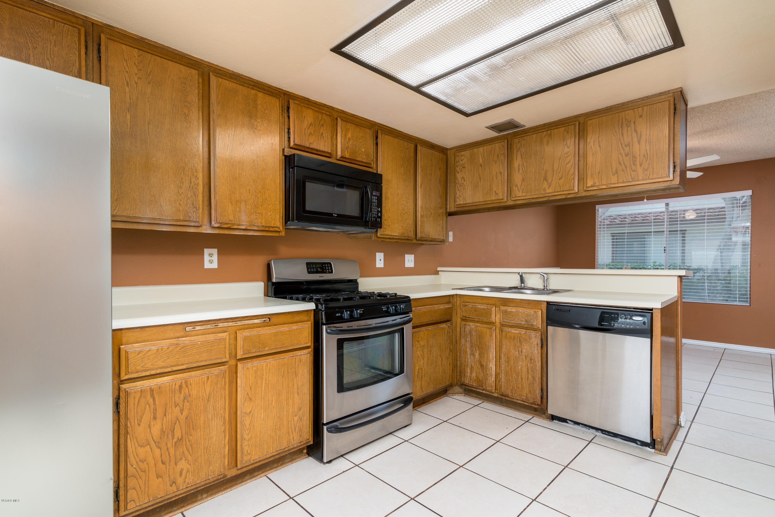 433 Percy Street Oxnard, CA 93033 - Photo 8 of 26 a kitchen with stainless steel appliances granite countertop a stove a sink and a microwave