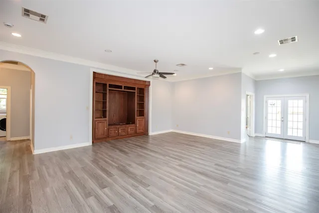 a view of a room with wooden floors and stairs
