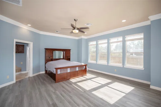 a living room with a bed furniture and a large window