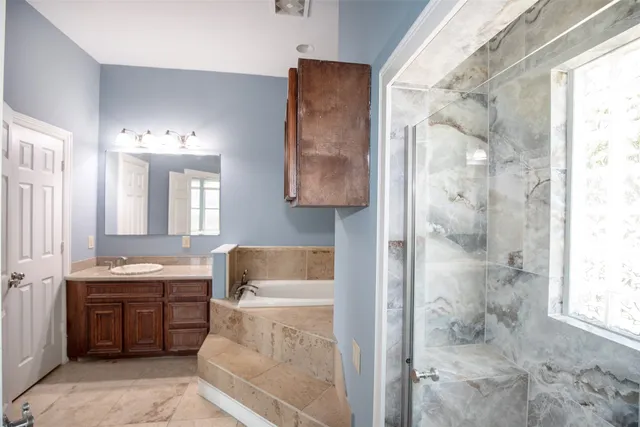 a room with a walk in closet and a bathroom