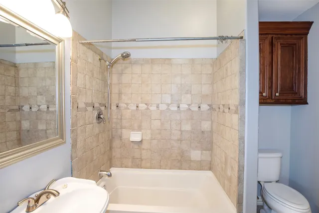 a bathroom with a shower and a toilet