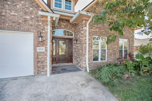 front view of a brick house with a large window