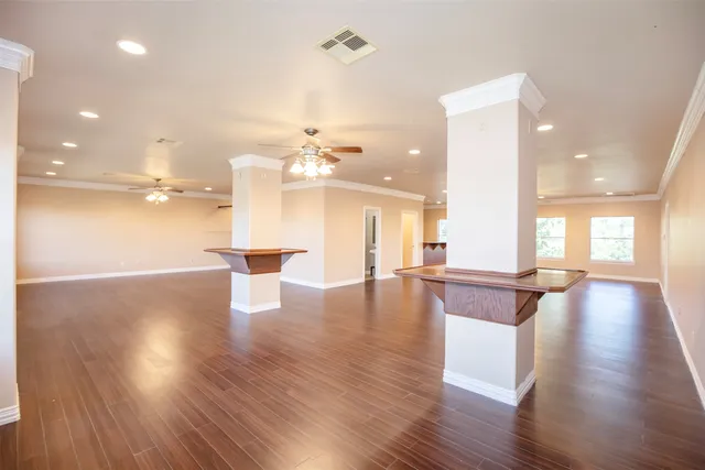 a view of a room with kitchen and wooden floor