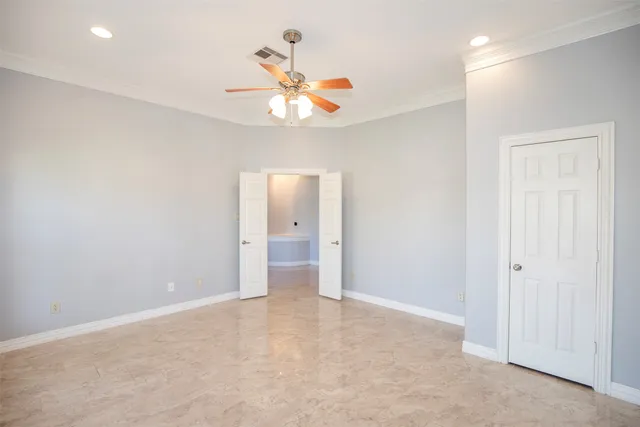 a view of a room with window chandelier fan