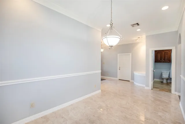 a bathroom with a granite countertop sink toilet and mirror