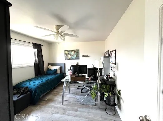 a bedroom with furniture and a large window