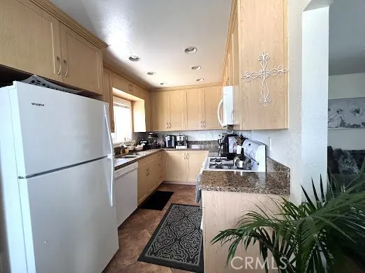 a living room with furniture and a refrigerator