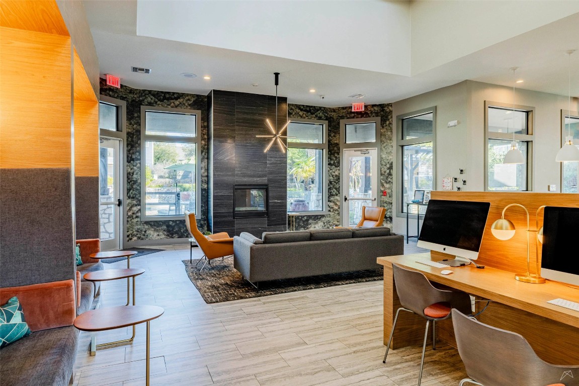 8515 Interstate 35, Unit 11102 Austin, TX 78744 - Photo 21 of 25 Living room featuring a fireplace, recessed lighting, light wood-style floors, and a desk
