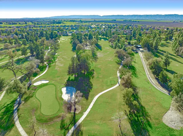 an aerial view of a houses with a yard