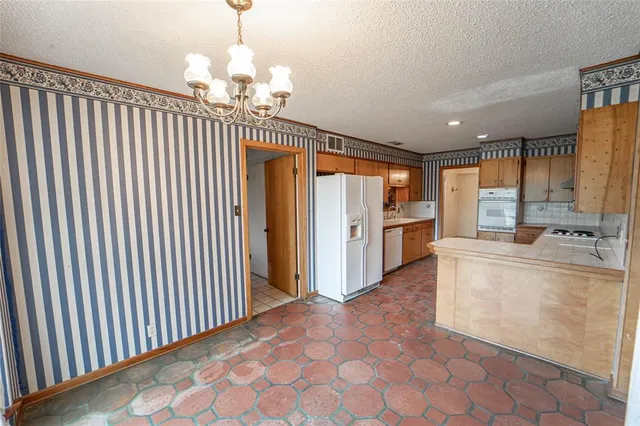 a very nice looking open kitchen with kitchen island a stove a sink and cabinets