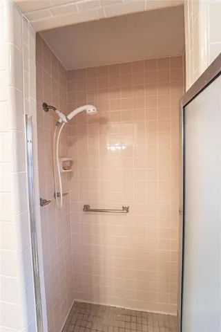 a bathroom with a glass door shower