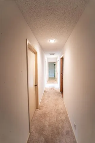 a view of empty room with stairs and closet